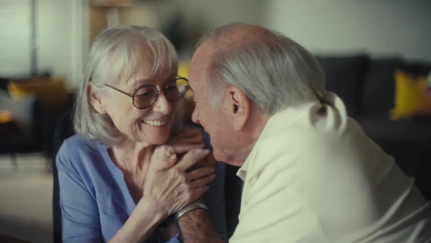 Elderly couple hug and laugh with contagious joy