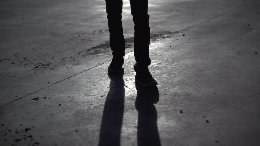 A person walking on a concrete floor