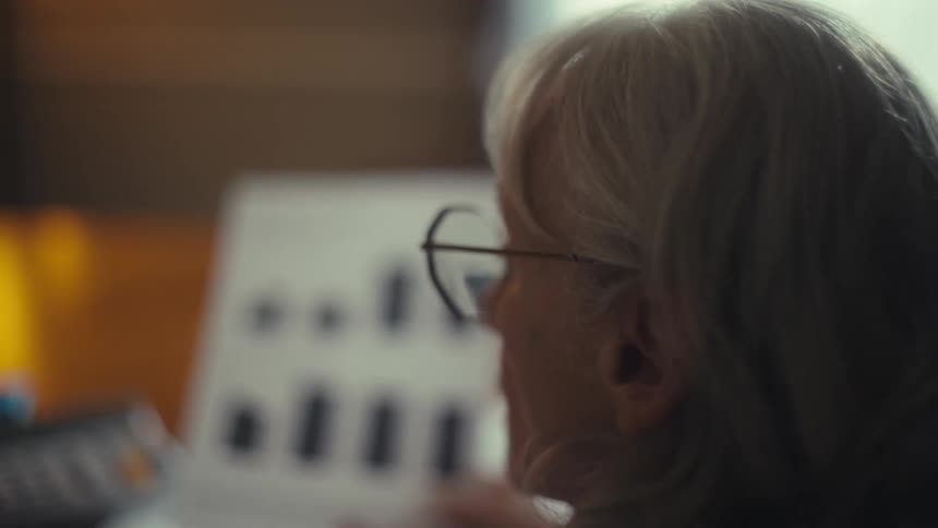 The man and woman have a discussion while reviewing papers