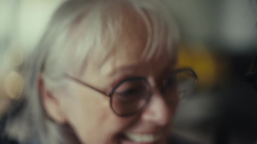 A couple talk and laugh while looking at a calculator