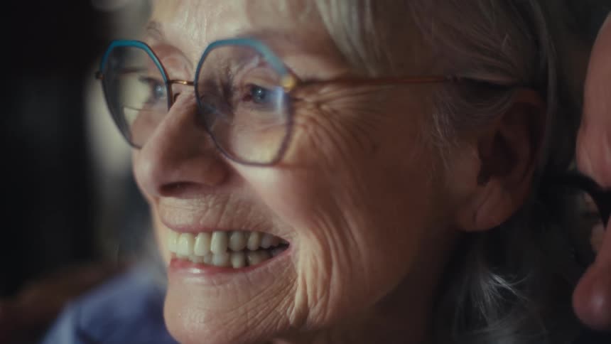 Elderly couple smiles with joy in a moment of closeness
