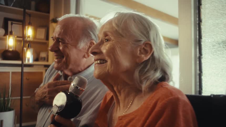 Smiling couple sings together holding the microphone
