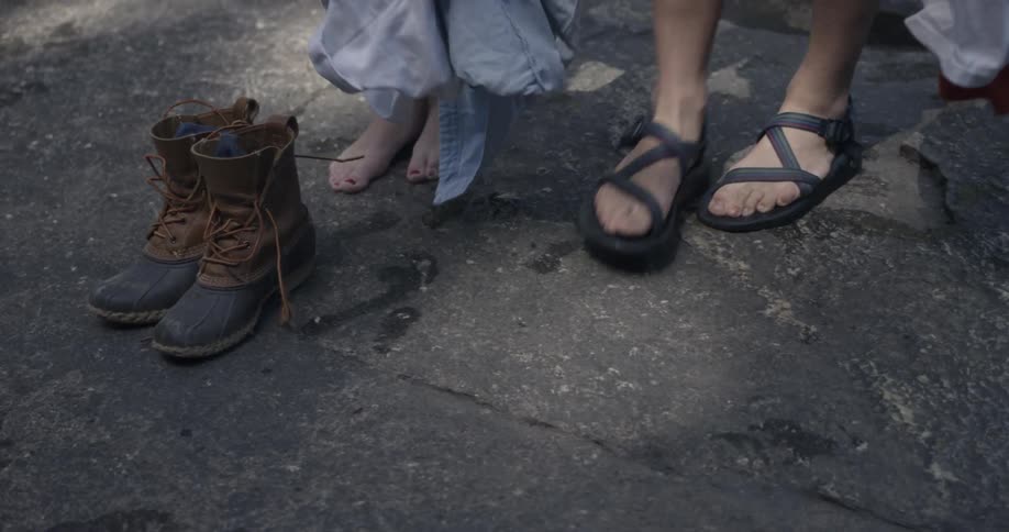 People pick up their clothing on the ground