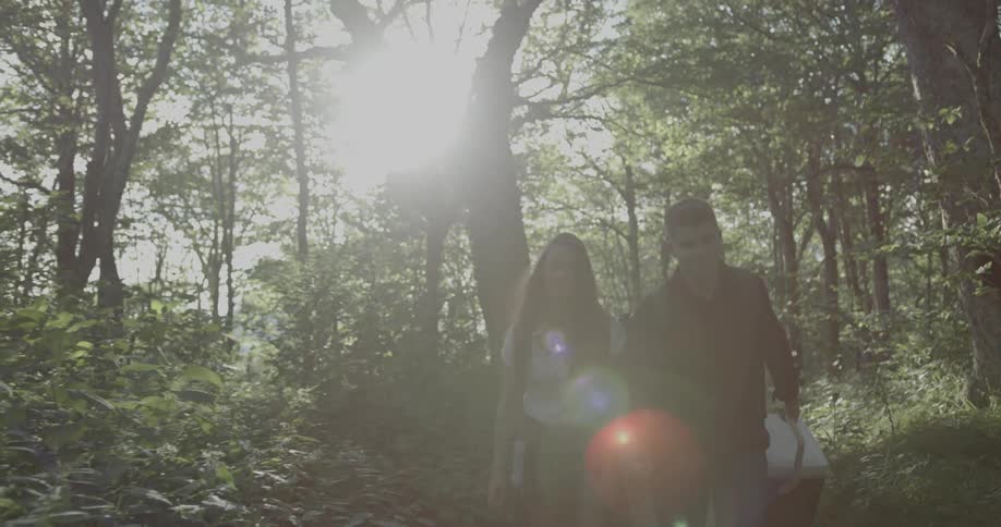 A man and woman talk and walk along a trail
