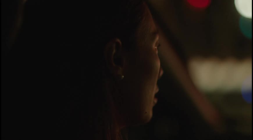 A close up portrait of an asian woman looking to the front with a blurry background