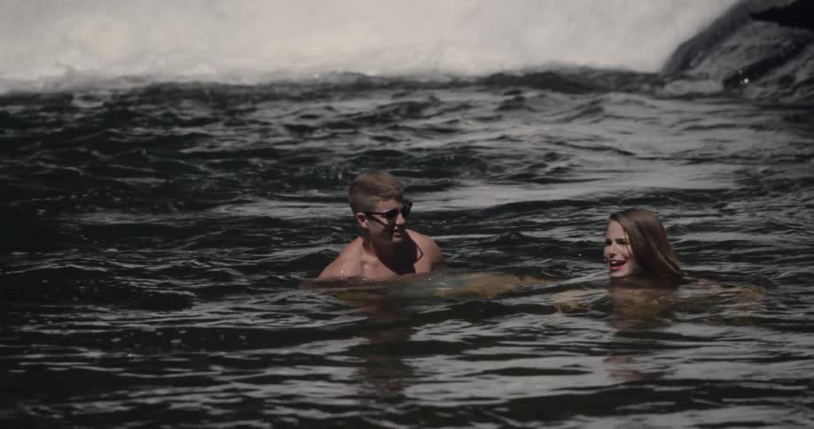A man and women play around in the water