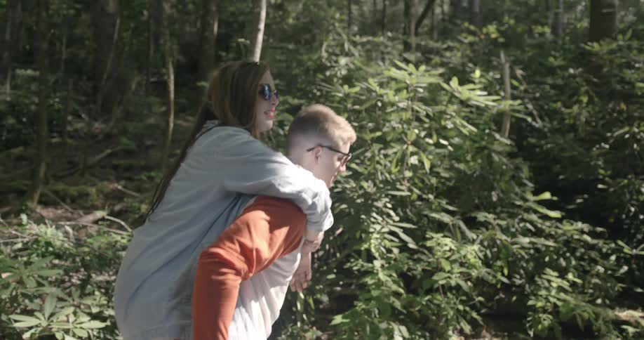 A man is giving a woman a piggyback ride