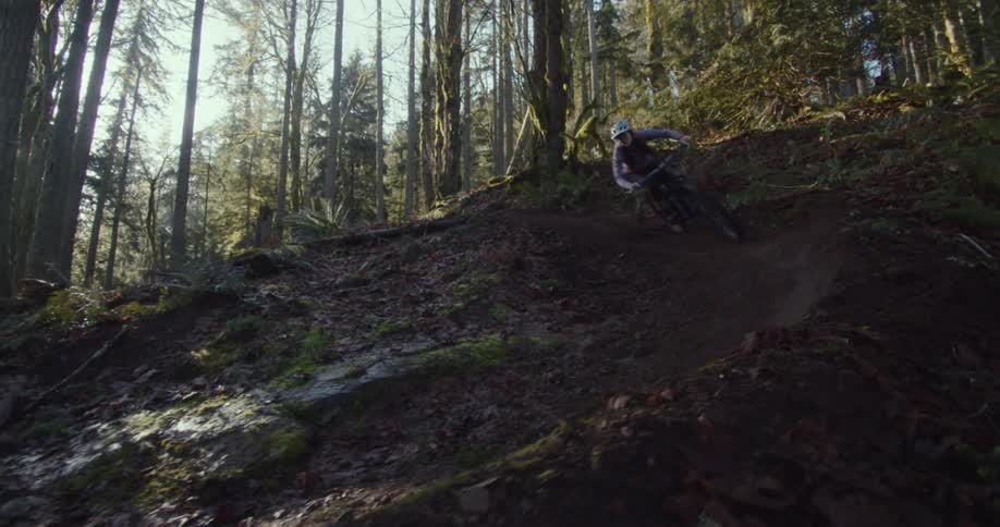 The woman speeds down the thin trail on the hill