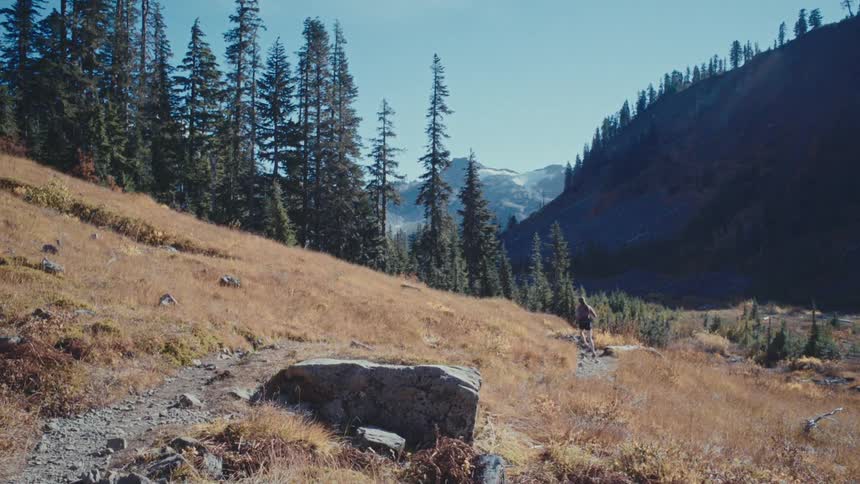Woman running on a mountain trail