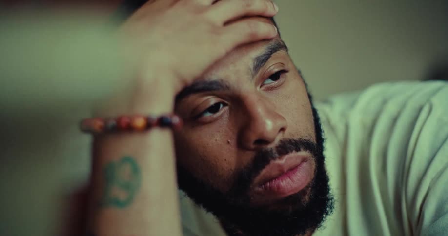 A man rests his head on his hand and lost in thoughts