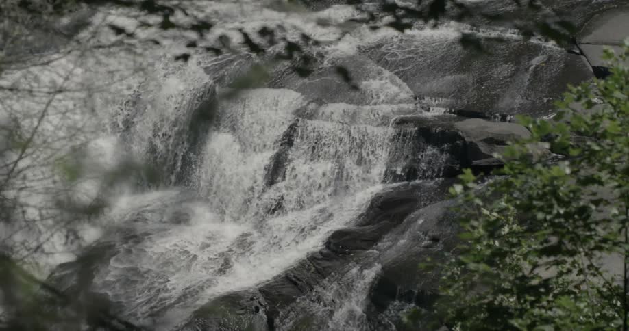 Water flows down a waterfall into a river