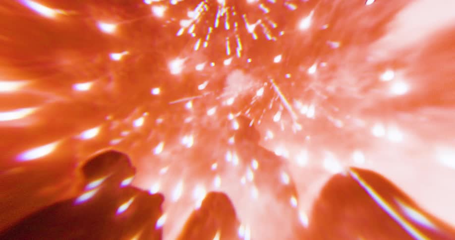 Burst of orange fireworks lights up the sky above silhouetted spectators