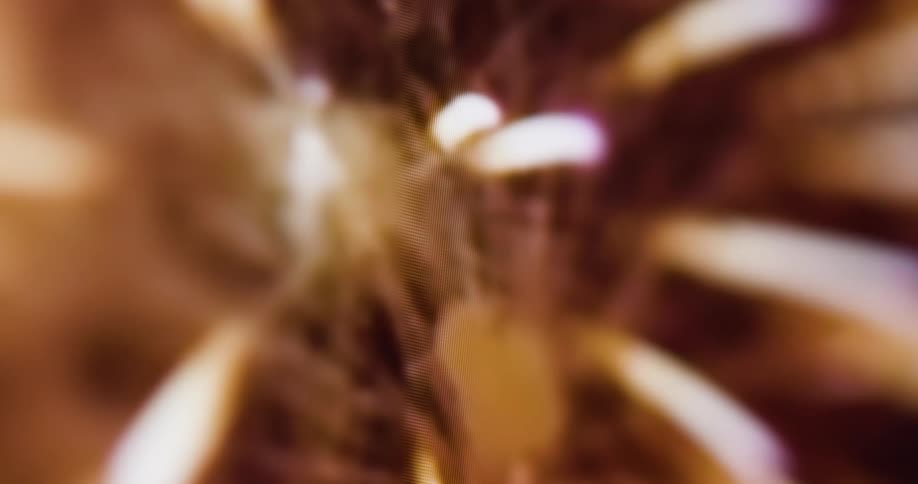 A close up of a screen showing a pixelate and blurry fireworks display