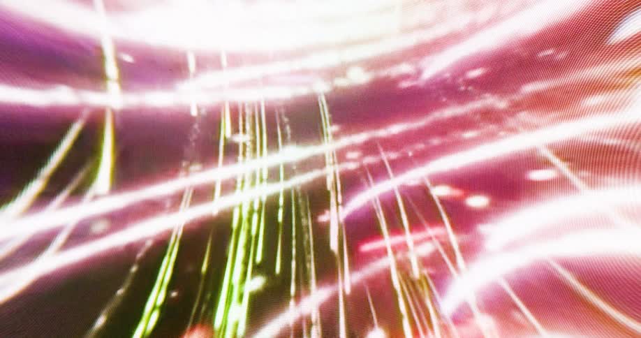 Colorful lights form complicated patterns against a black background