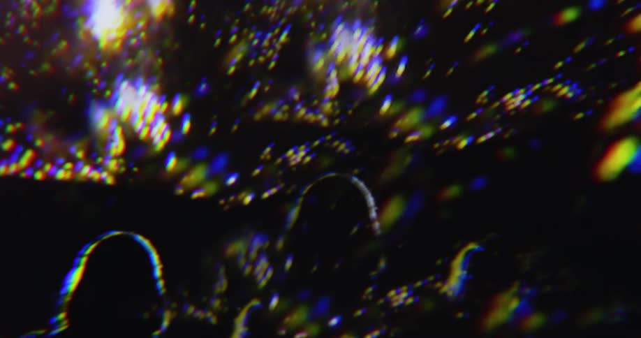 A shot from a firstperson perspective looks up at a light show or fireworks display the sky is dark and the bright shimmering lights create a sense of wonder