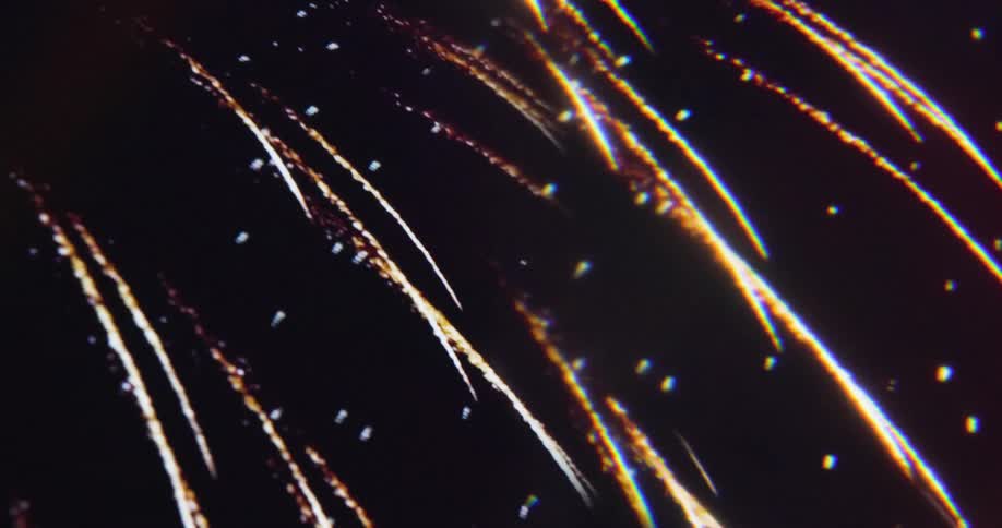 Fireworks burst in the dark night sky illuminating the atmosphere with different colors and patterns of light