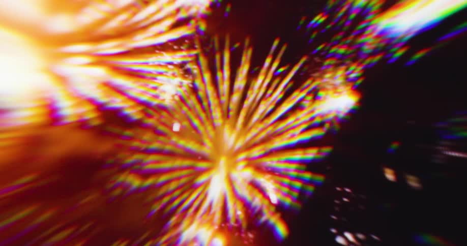 A shot of colorful lights that appear to be fireworks exploding in the dark the streaks of light and blurry colors give the scene an abstract and dynamic feel
