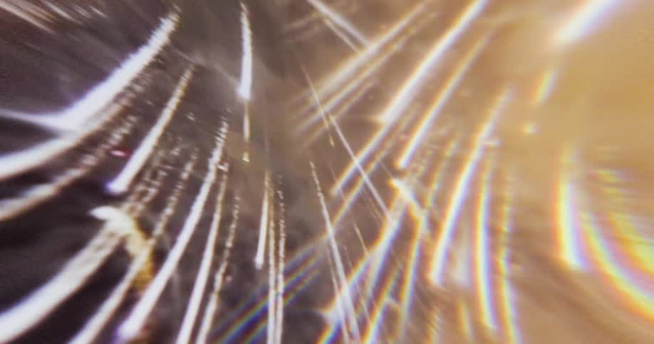 A bright burst of red and white fireworks explodes across the night sky