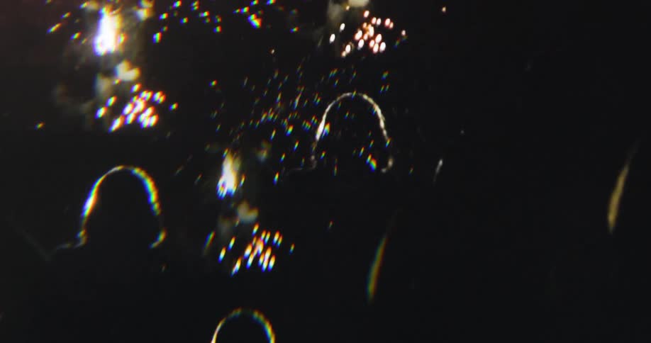 Silhouette of people watching fireworks at night