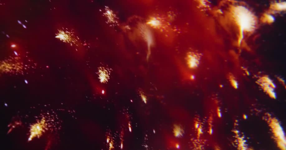 The fireworks fill the sky with red and yellow at night