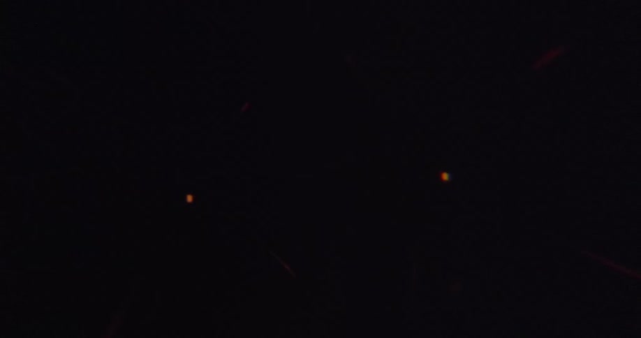Golden fireworks burst brightly against the dark night sky