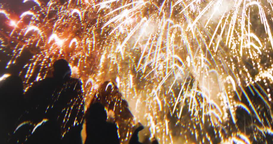 Silhouette of people watching a fireworks festival