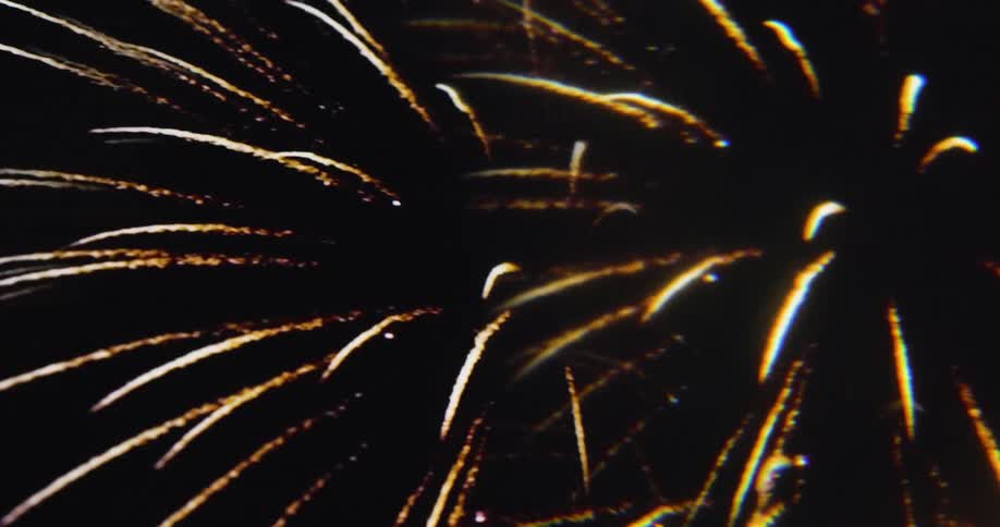 The fireworks explode rainbow colors at night