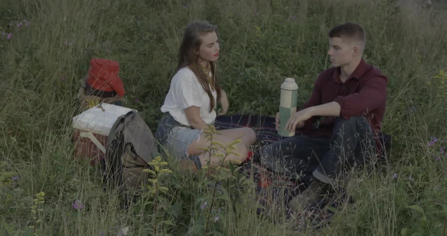 A boy and girl have a picnic