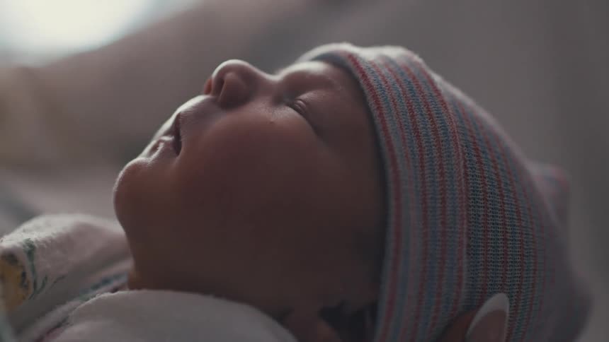 A close up shot of a sleeping newborn baby the baby is looking very cute