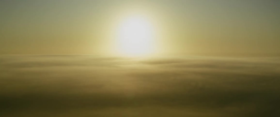 Above the clouds the sun is covered by haze