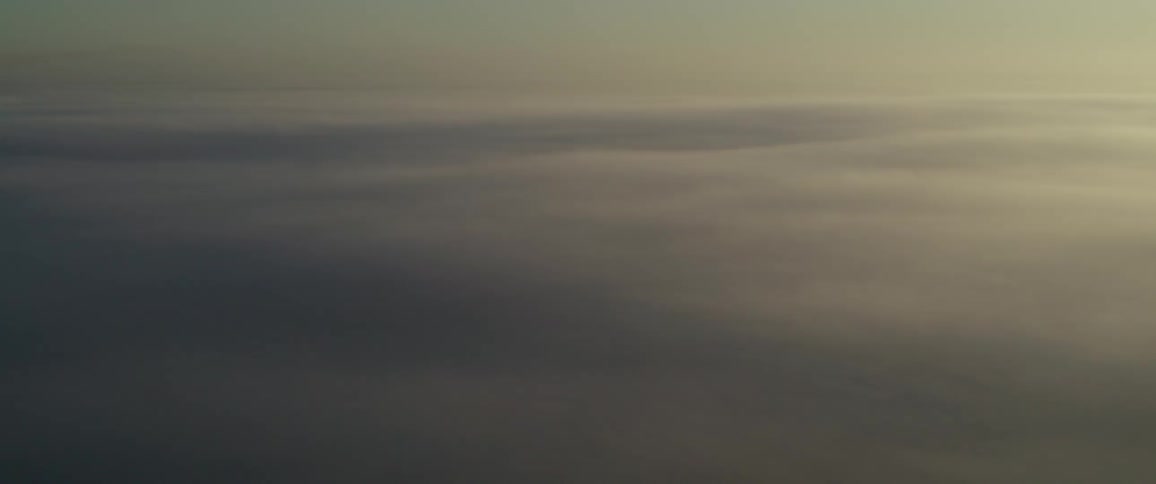 Thick layer of clouds illuminated by the soft light of dawn