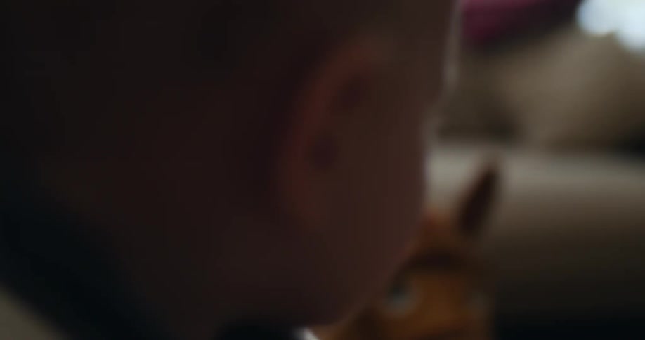 A child is playing with his toys in the living room
