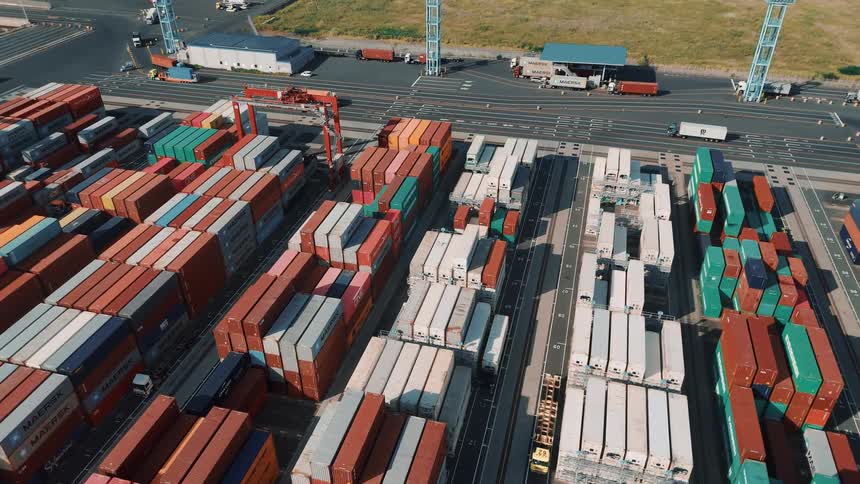 Colorful stacked shipping containers organize the area of a cargo port