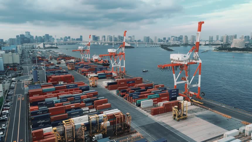 Panorama of a port with containers on the waterfront and a city in the background
