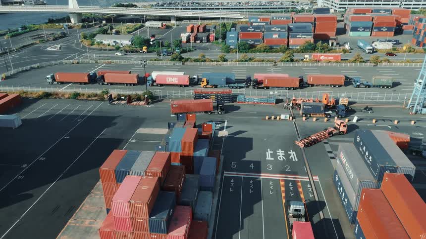 Aerial view of trucks in a port moving containers