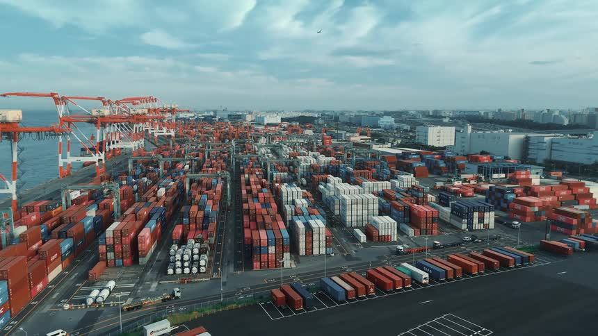 A commercial port with a large cargo shipping container depot