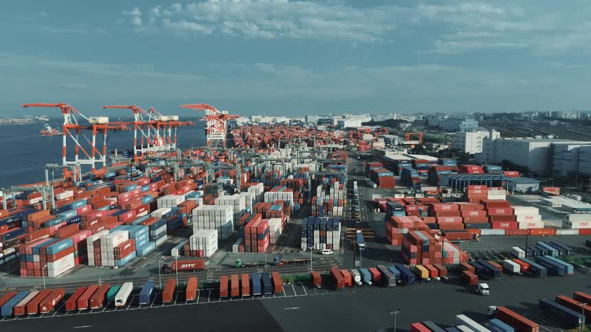 Massive shipping yard packed with colorful containers cranes and trucks near the waterfront