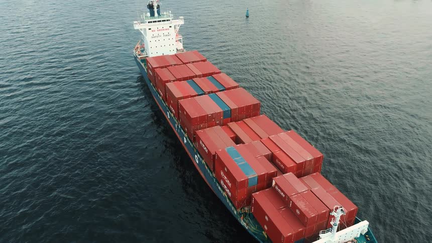 Ship with containers traveling at sea