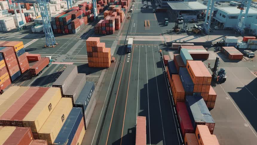 Cargo trucks on the roads in a large cargo shipping container depot