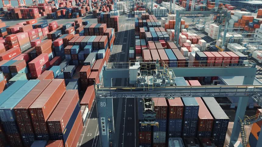 Aerial view of a port a truck is moving carring a container