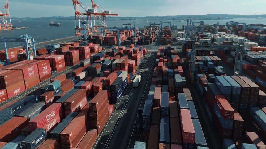 Truck passing through a logistics port with containers