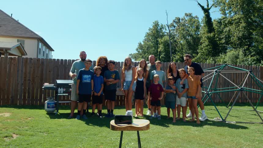 A group pose for a picture in the yard