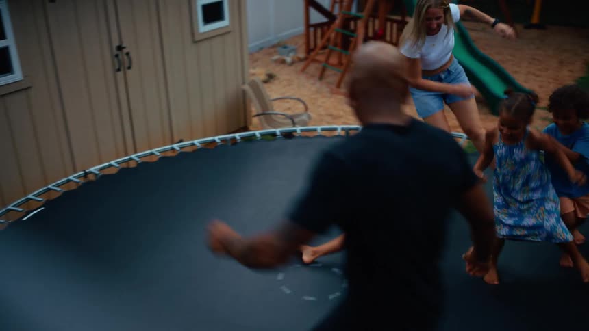 The family fall and jump on the trampoline
