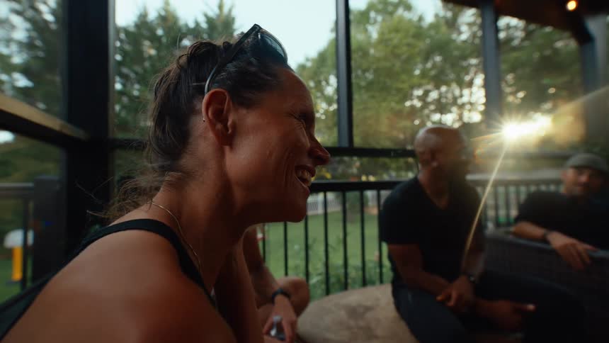 Friends talk and laugh on the porch