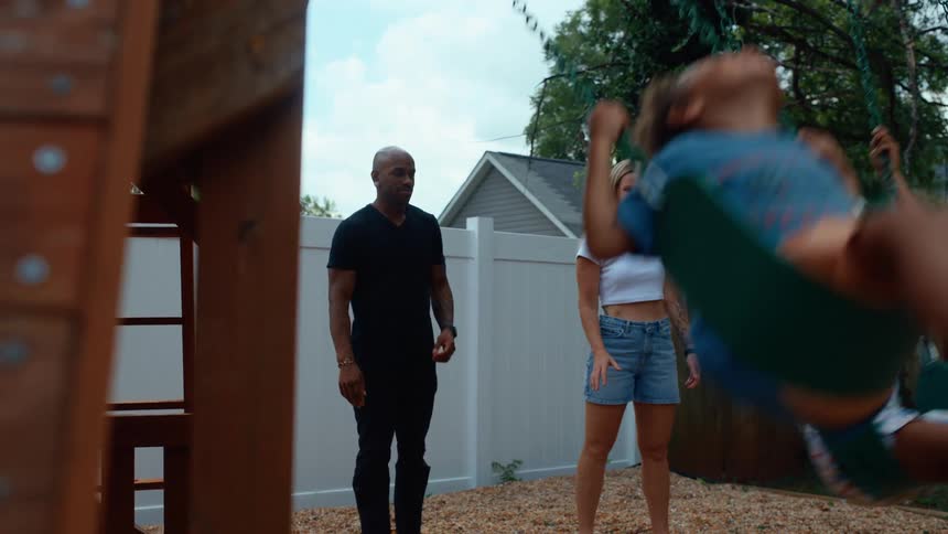 Parents push their children on the swings