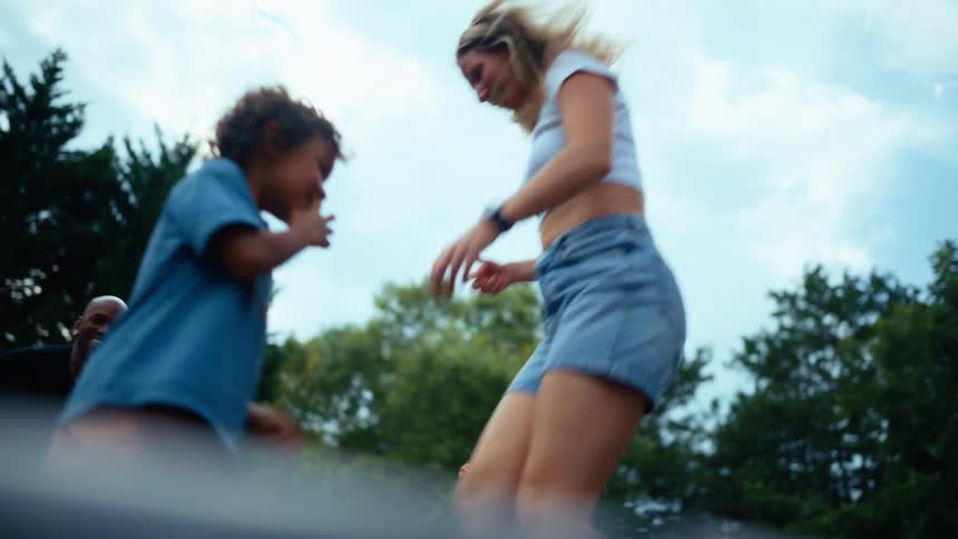 The family bounce high on the trampoline