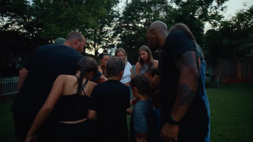 A group are huddling in the middle of the yard