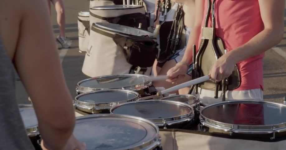 The band member is tapping the drums