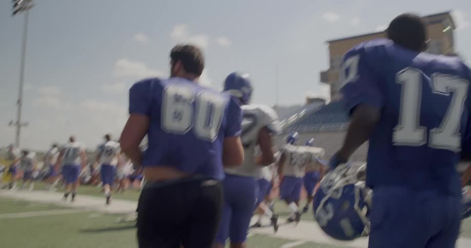 The players all run off the football field together