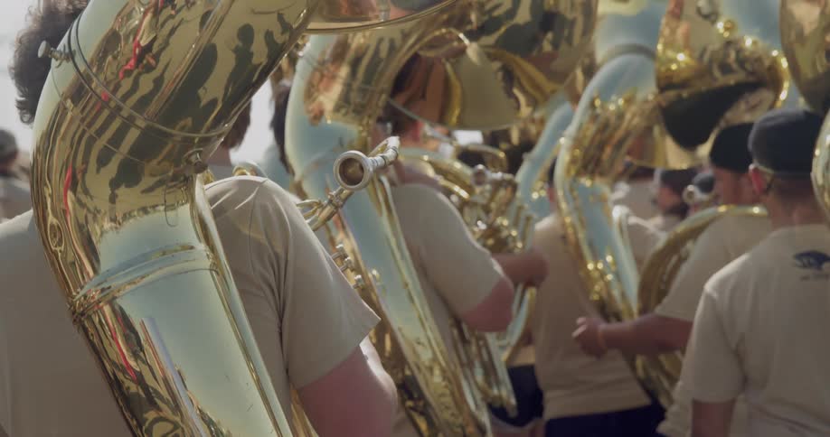 The band are all holding brass horns